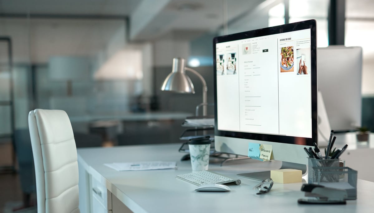 Shot of a desk in a modern office setup with a chair and desktop computer