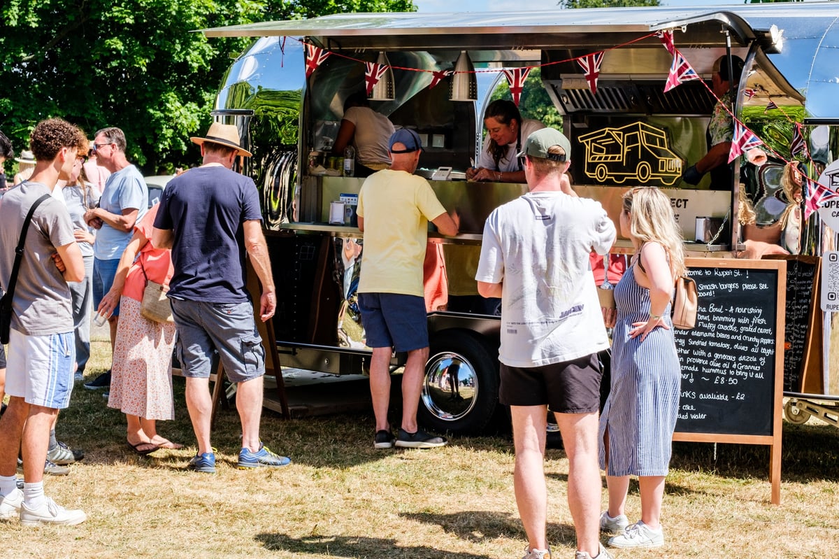 People queuing to buy food from a mobile American style food truck