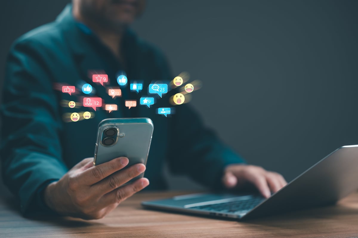 Business person managing social media marketing campaigns through mobile device