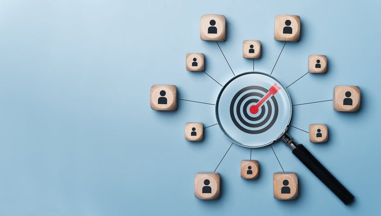 Magnifying glass targeting a bullseye surrounded by connected user icons on blue background, representing audience targeting or customer focus